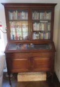 An unusual Edwardian bookcase on display bureau having twin doors under, 130 x 53 x 200cm.