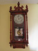 An early 20th century eight day striking English wall clock, enameled dial with Roman numerals,