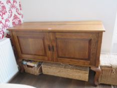 A mid century oak two door sideboard raised over plain cabriole legs, 136 x 49 x 87cm.