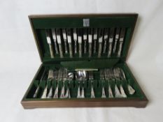 A part set of cutlery in wooden canteen.