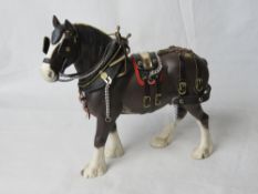 A Beswick shire horse in harness.
