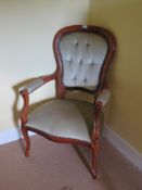 A 20th century buttoned tongue back open arm chair.