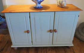 A contemporary green painted pine top three door cabinet,