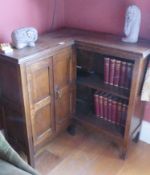 An unusual oak corner unit comprising double doors with open shelves on the return,