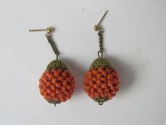 A pair of early century gilt metal and faux coral bead earrings.