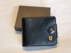 An as new Ferrari themed wallet, within box, enamelled badge to front.