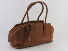 A tan leather handbag by Fiorelli approx 35cm wide. Slight wear noted to handles.