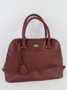 A burgundy leather handbag by Storm London, approx 35cm wide.