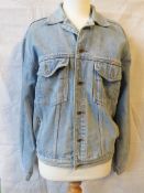 A vintage blue jean Wrangler denim jacket, size small.
