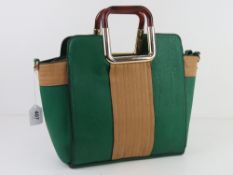 A contemporary green and tan handbag having lucite type plasticised handles, approx 29cm wide.