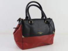 A red and black leather handbag by Fiorelli approx 26cm wide.