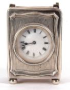 A George V silver cased boudoir carriage clock, the clock has a white enamel dial, black Roman