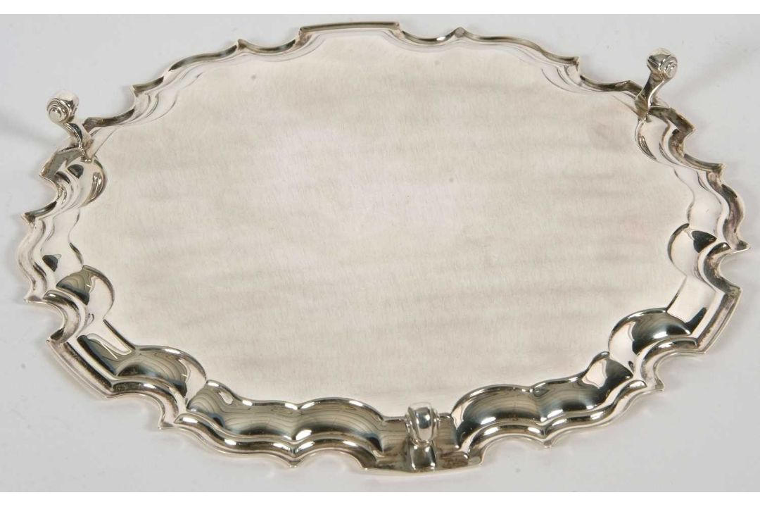 A sterling silver card salver of plain form, having pie crust edge and supported on three cast - Image 3 of 3