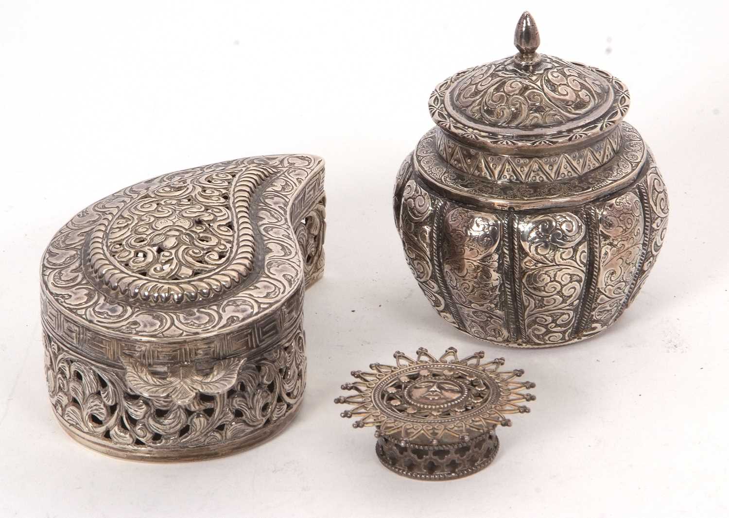 Mixed lot comprising a continental white metal small vase and lid, chased and engraved all over with