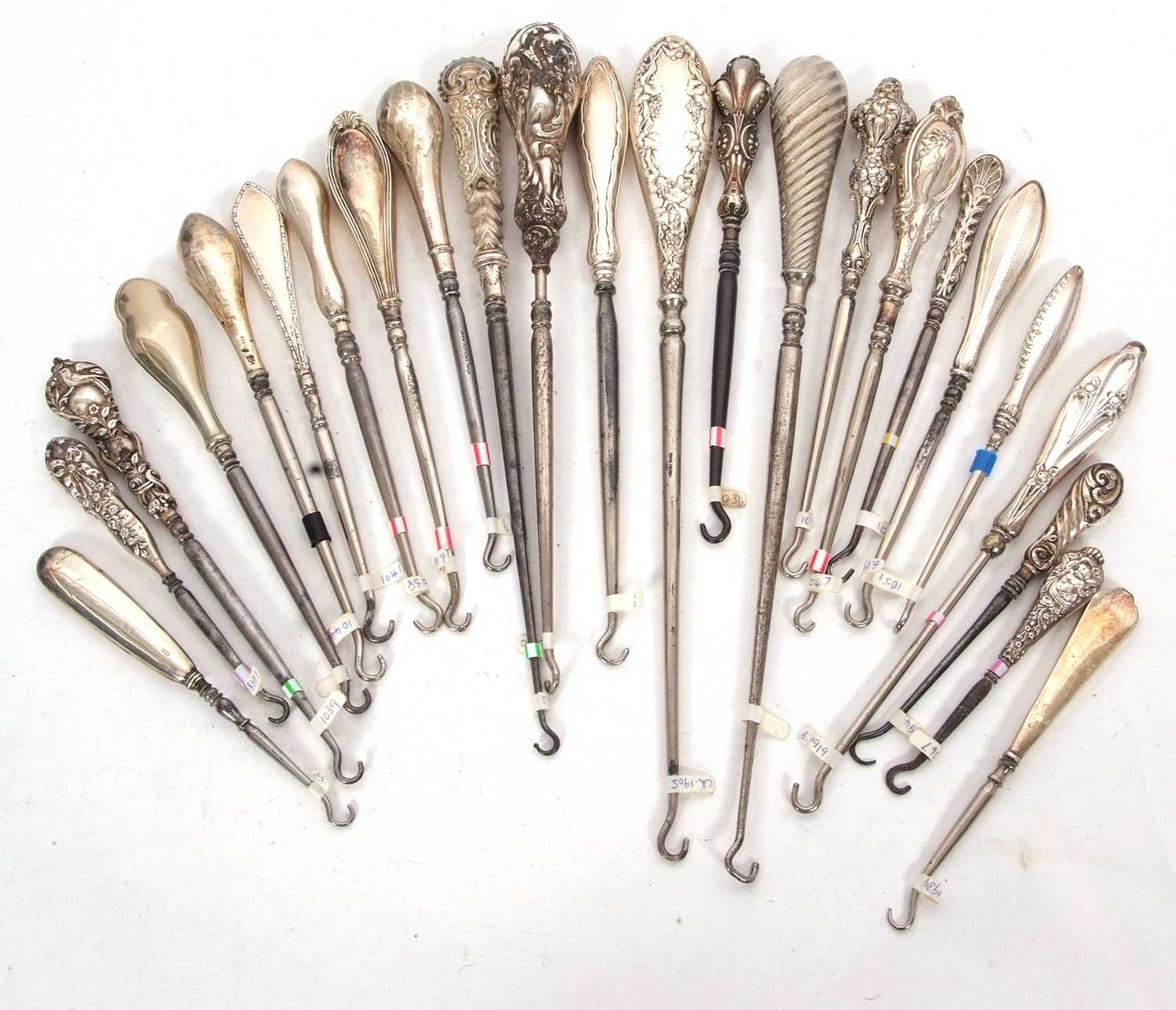 Group of twenty four late 9th/early 20th Century silver and steel button hooks, various dates/
