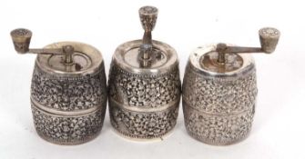 Group of three French barrel shaped white metal cased spice/nutmeg graters, stamped 