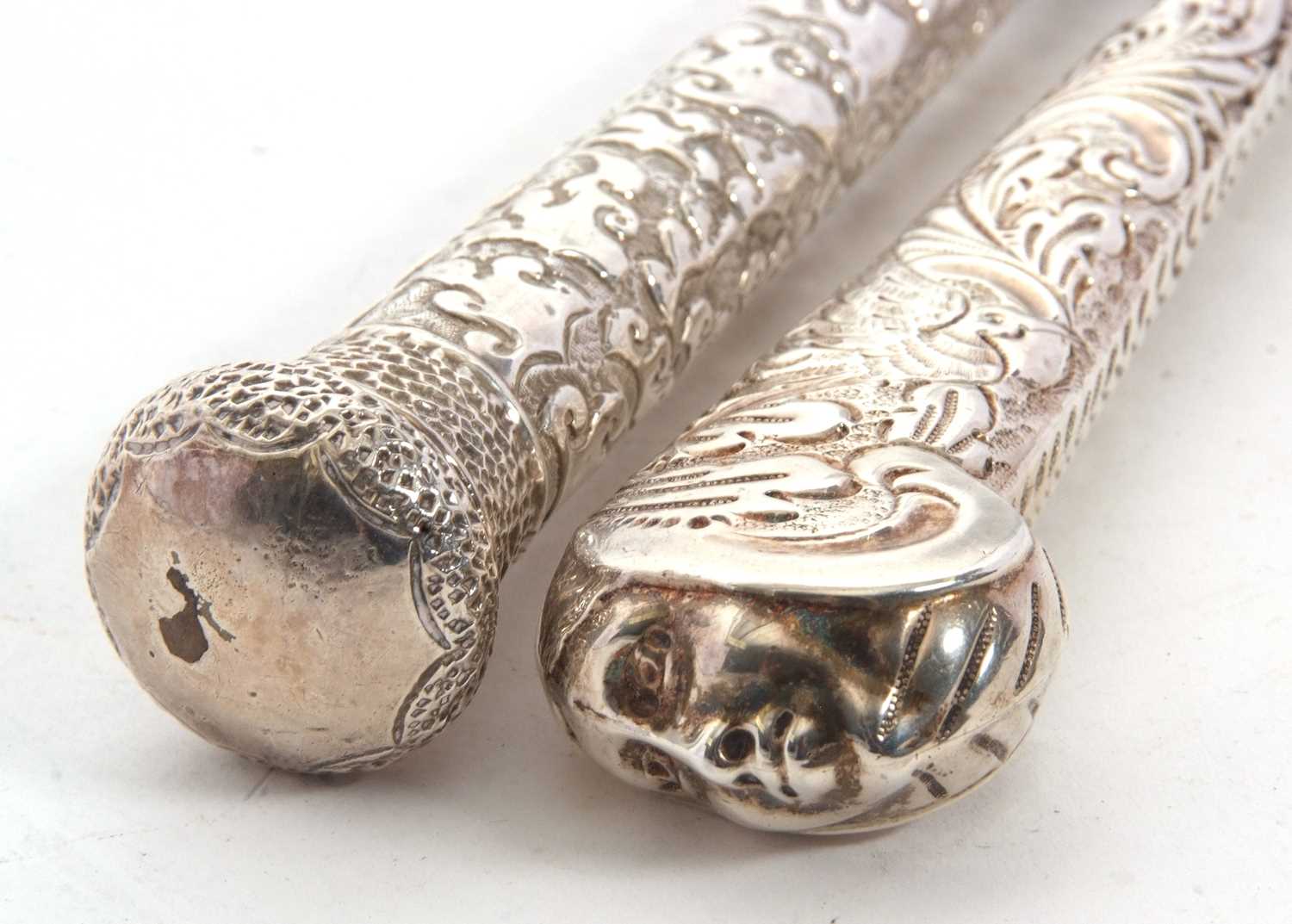 Two Victorian long handled button hooks, one with the handle in the form of a walking cane handle,