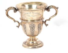 A George V small silver twin handled trophy, the top section engraved 