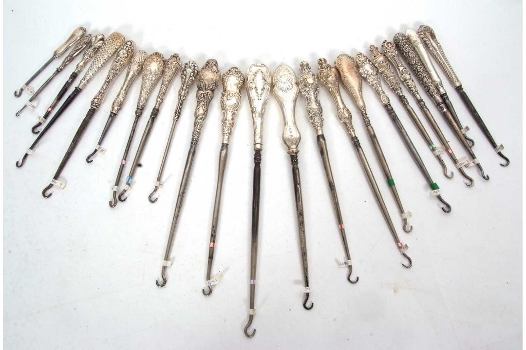 A group of twenty two late 19th/early 20th Century silver and steel button hooks, various dates/ - Image 1 of 4