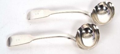 A pair of William IV fiddle pattern sauce ladels having over shaped bowls and engraved with