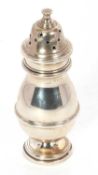A George V silver caster of plain baluster form, pull off pierced lid and supported on a spreading