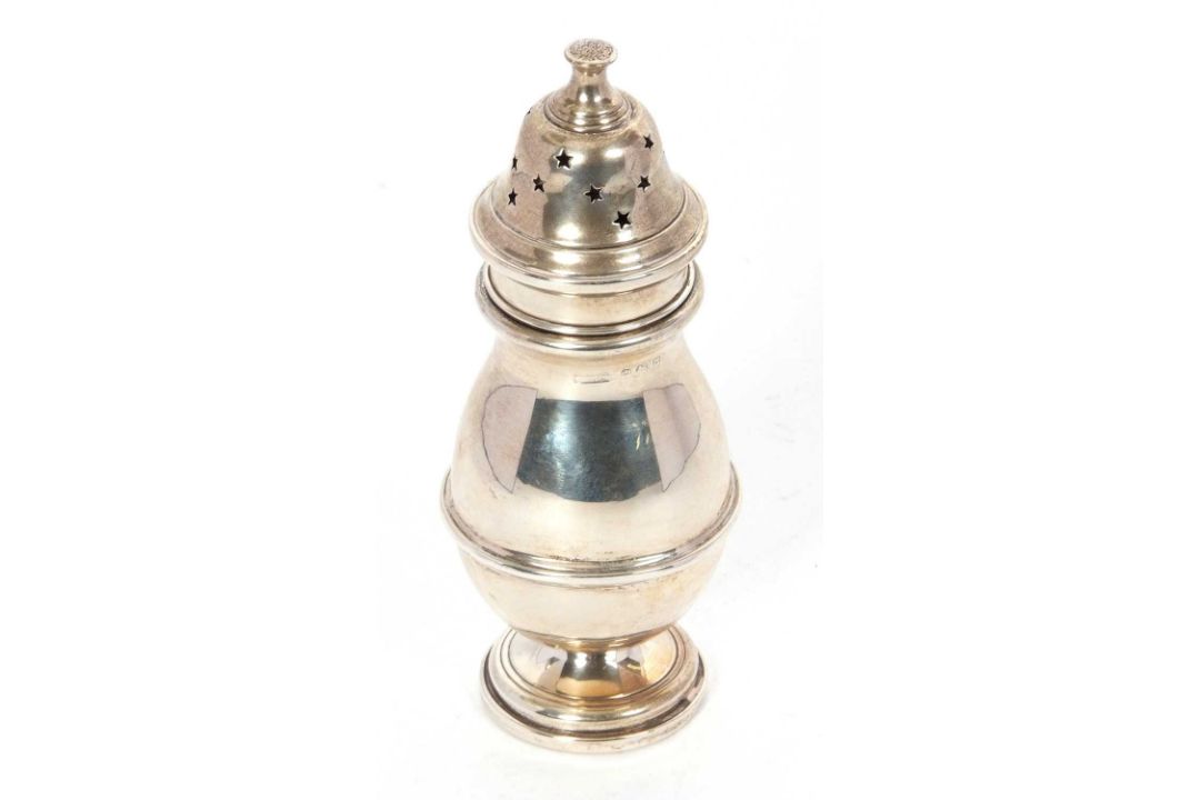 A George V silver caster of plain baluster form, pull off pierced lid and supported on a spreading - Image 1 of 2