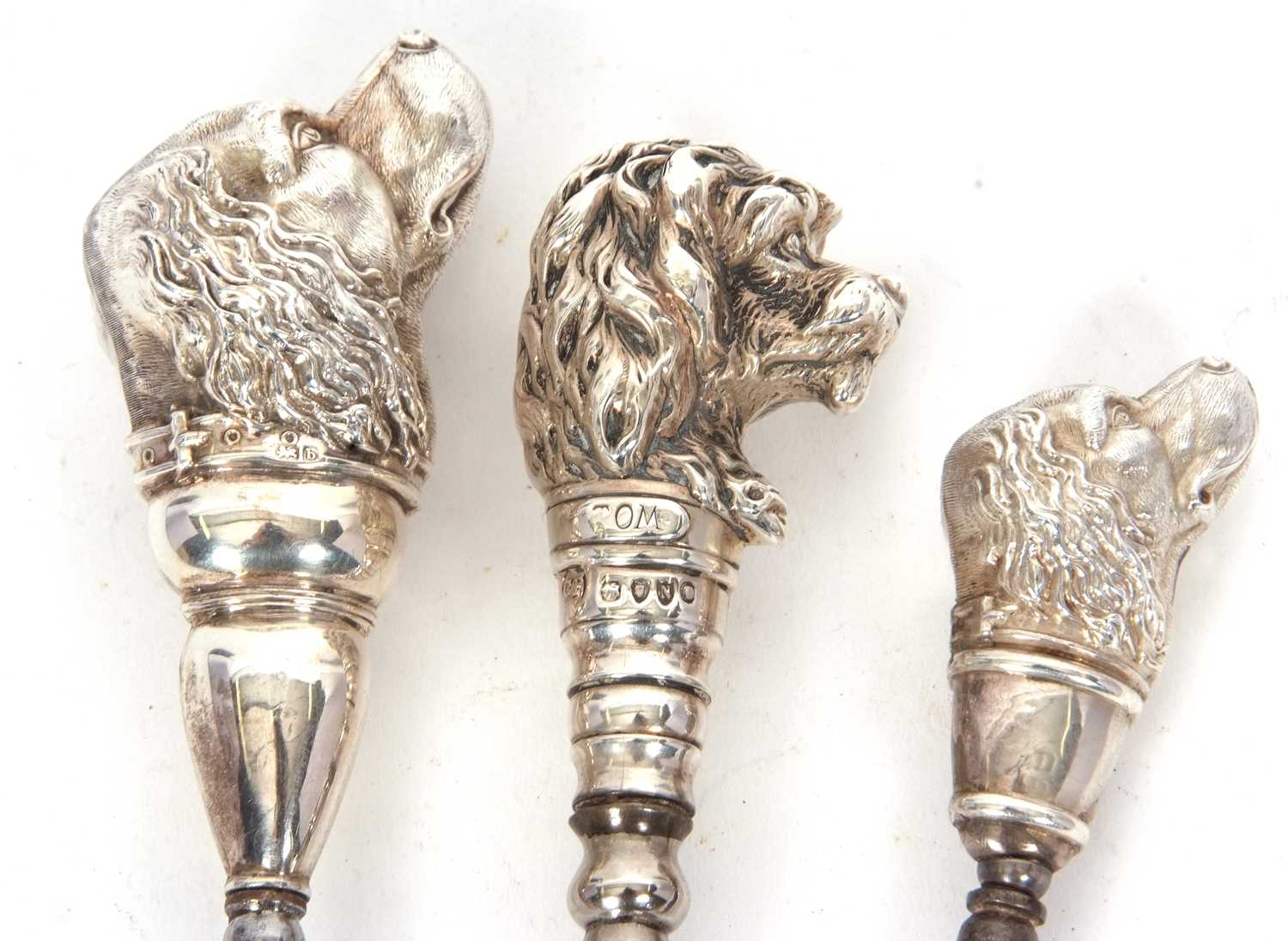 A group of three button hooks to include a Victorian silver mounted novelty "dog" button hook,