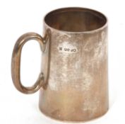 A Victorian silver tankard with glass bottom, of plain slight tapering form having a C scroll