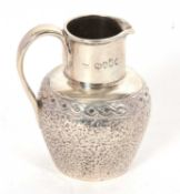 A Victorian silver small cream jug with plain polished collar and handle, the baluster body chased