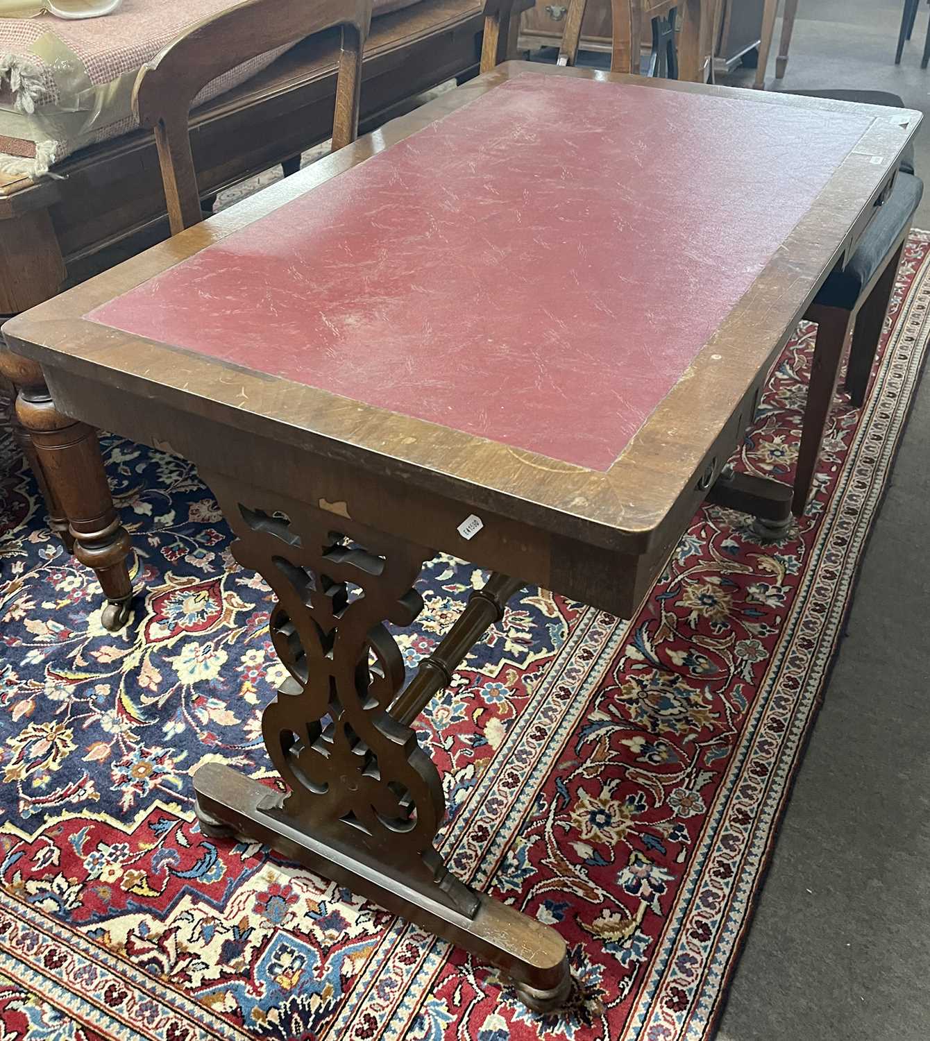 A Victorian mahogany veneered writing table with two drawers, pierced end supports and a central - Image 2 of 2