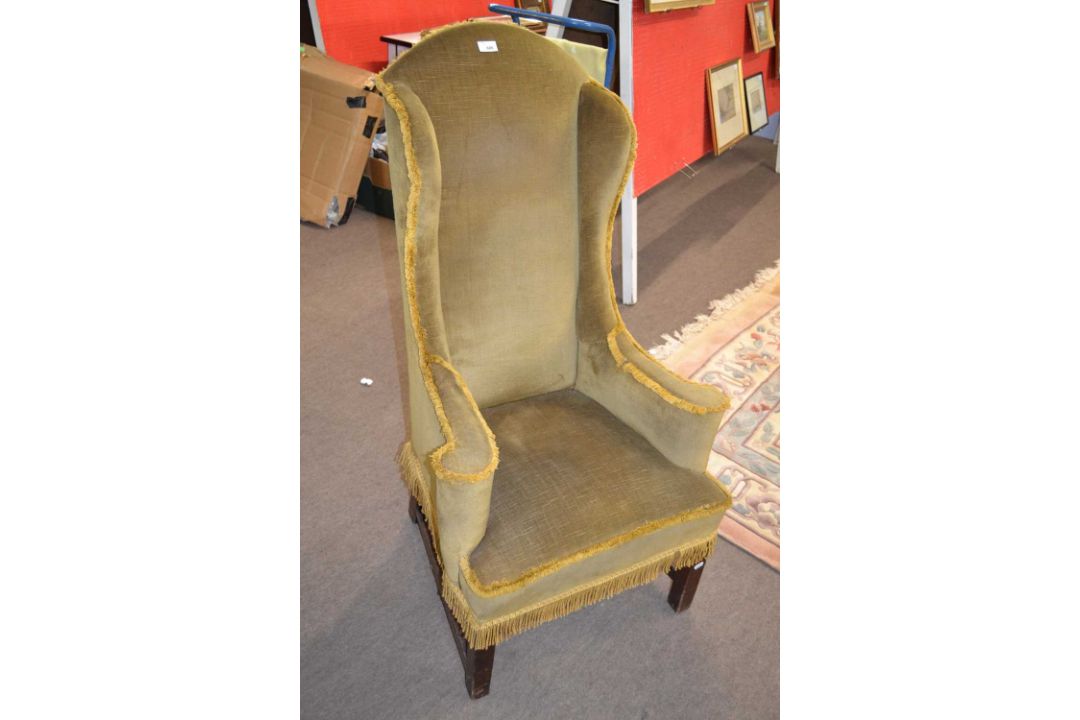 A narrow Georgian style wing back armchair, 118cm high