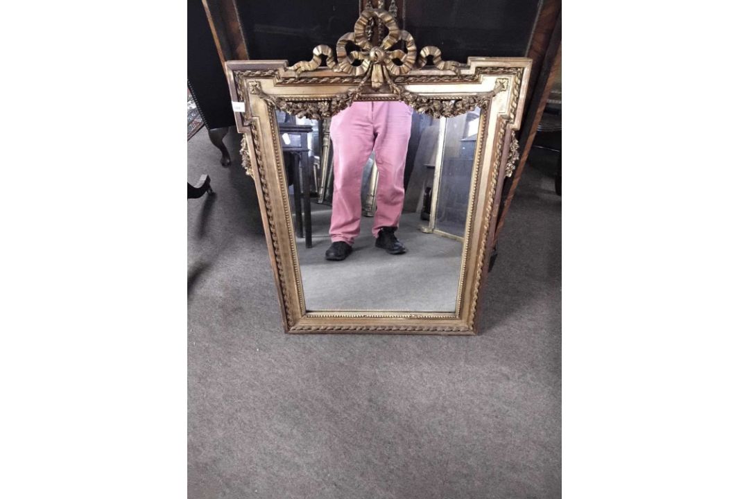 19th century and gilt framed wall mirror, the frame with ribbon and swag mounts, 68 x 95cm max