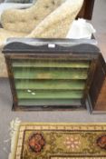 A small 19th Century table or counter top display cabinet with ebonised frame and green painted