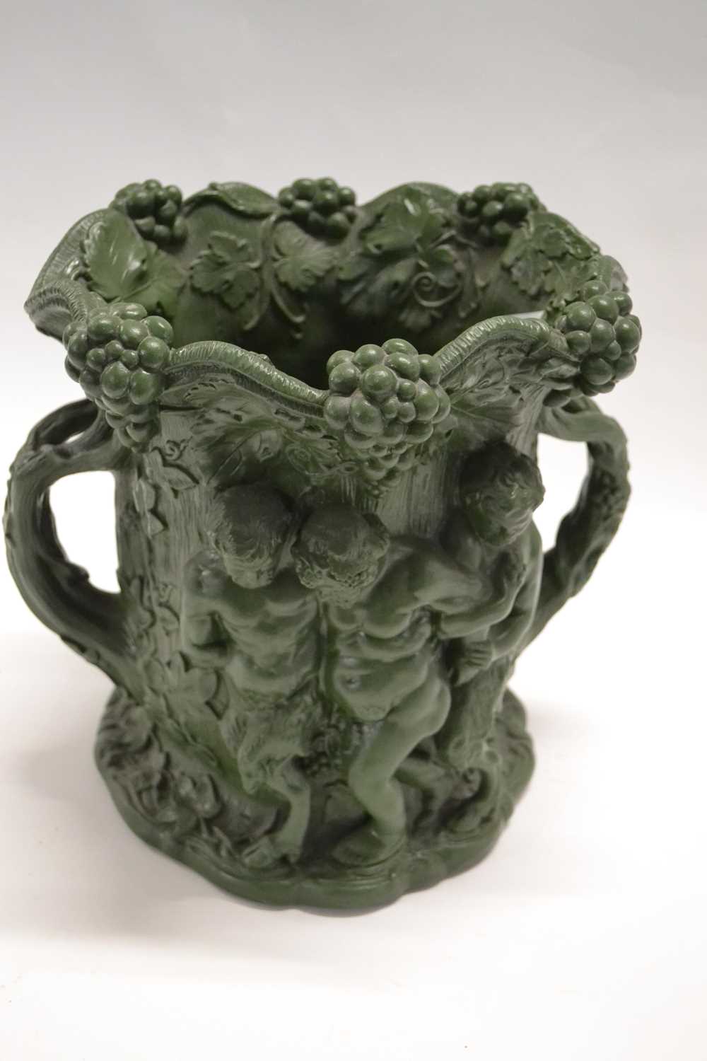 A large 19th Century green glazed Bachus jug modelled also with the Silenius donkey with applied