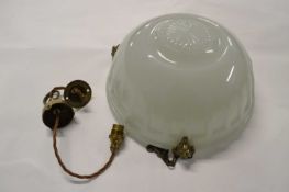 An Art Deco style moulded opaque glass ceiling light fitting with chain supports and brass goats