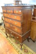An 18th Century and later walnut veneered chest on stand, the top section with three short over