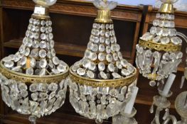A pair of cut clear glass and metal mounted ceiling light fittings of circular form, 45cm high