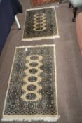 A near pair of small 20th Century geometric pattern floor rugs, the largest 103cm long (2)