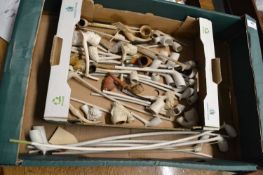 A box containing a collection of various mainly clay pipes in a variety of designs to include Church