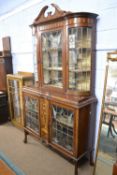An Edwardian mahogany framed display cabinet with lead glazed doors decorated with peacock feather
