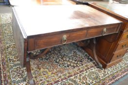 A Georgian mahogany sofa or centre table of typical form with drop leaves, two drawers and two dummy