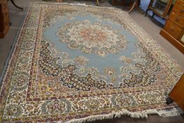 A modern Kashan type rug with a floral design and a large central blue panel, 300 x 395cm