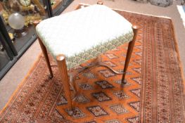 A late 19th Century mahogany stool with tapering legs and X formed stretcher, 46cm wide
