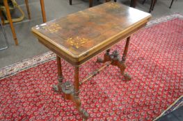 Victorian walnut veneered and inlaid card table with folding top, turned end supports and scrolled