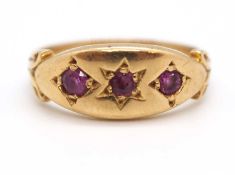 An 9ct ruby ring, the three round gypsy set rubies with plain band stamped 9ct, size I-J, 2.9g