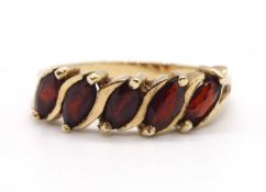 A 9ct five stone garnet ring, set with five marquise shape garnets with split shoulders and