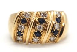 A sapphire and diamond ring, the broad 11mm wide band set with three diagonal rows of alternating