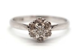 An 18ct white gold cluster ring, comprised of illusion mounted single cut diamonds, with plain