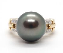 A 9ct cultured pearl and diamond ring, the round grey cultured pearl, approx. 12mm diameter, in a