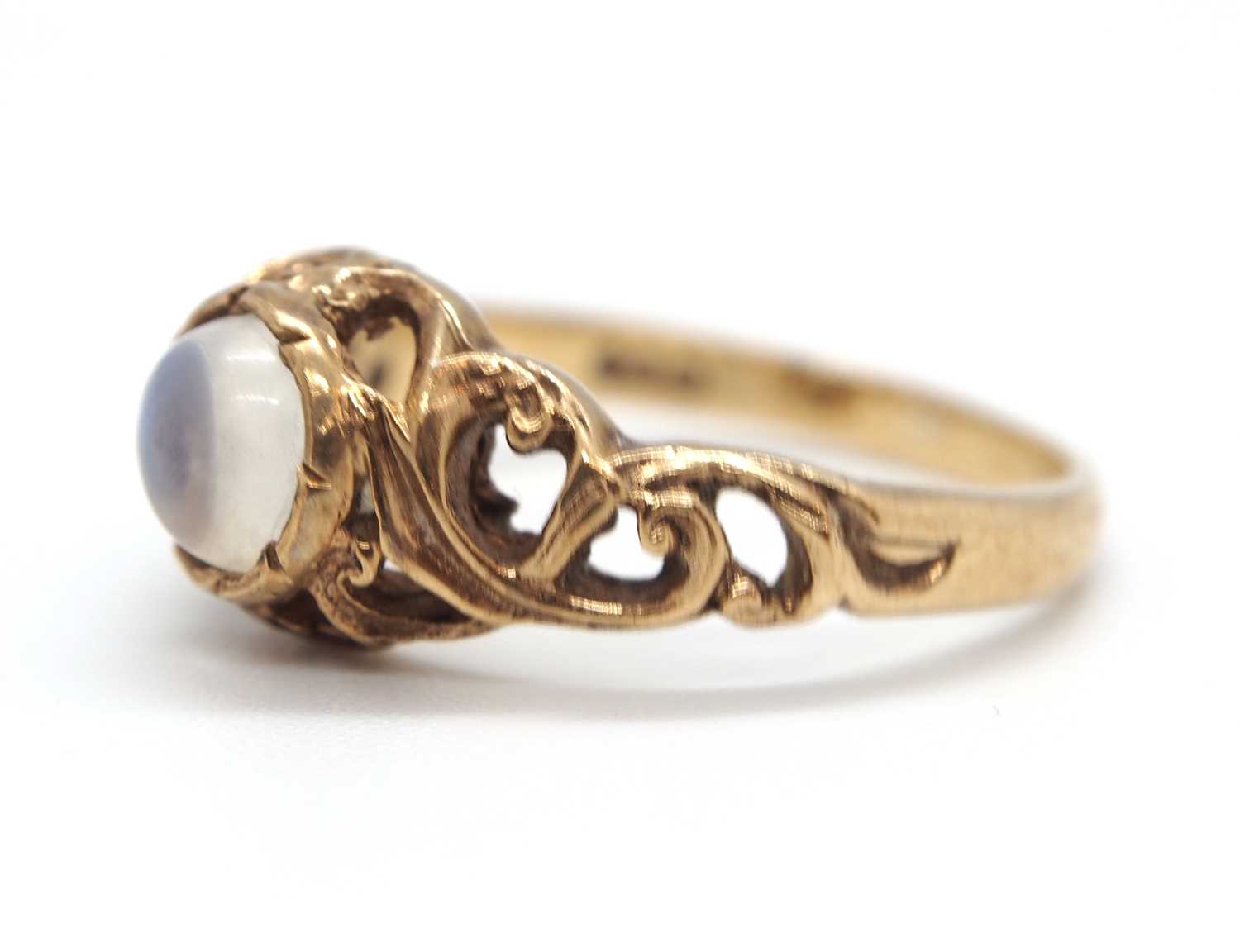 A 9ct moonstone ring, the round moonstone cabochon in a rubover mount with scrolled surround - Image 4 of 5